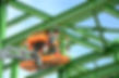 Workers are working on the Orange articulate boom lift or telescopic boom lifts and bucket
