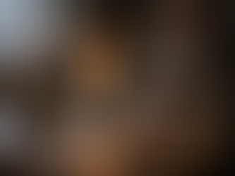 Candlelit Irish cottage ritual table with steady flame, stone, and water bowl beside a calm seated witch, symbolising trust, alignment, and the quiet role of belief within traditional Irish Craft practice.