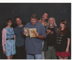 SlayerLit photo of Founder Gene Popa reading a Buffy book.. Standing with him are  Juliet Landau, James Marsters, Doug Jones, Camden Toy, Amber Benson