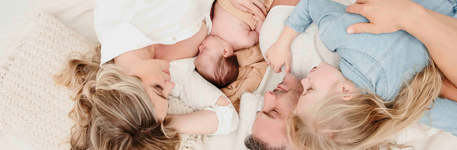 Family portrait having a great time on a day bed