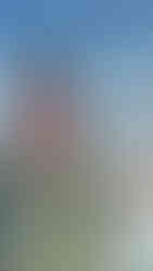 woman at the snow applying sunscreen lip balm to her lips