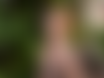 woman in a swimsuit under an outdoor shower