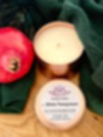 Handmade Winter Pomegranate Coconut Soy Candle by Ajnayoga made in Switzerland. As a background a pomegranate and a scarf