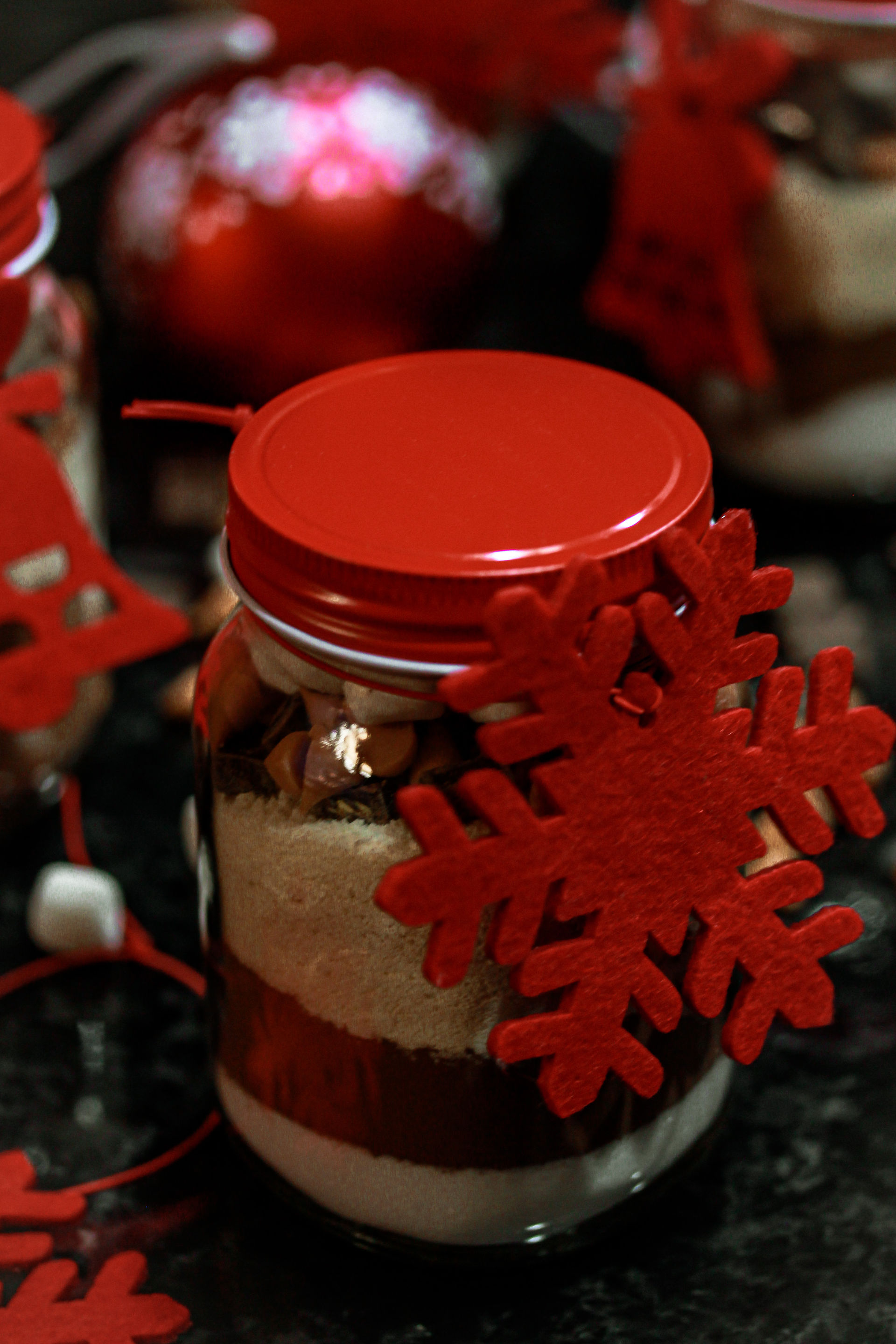 Homemade butterscotch hot chocolate mix in bottles with marshmallows—easy holiday gift idea or winter drink recipe.
