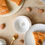 Thumbnail: White polar bear fève on white bowl displayed on laid table with king cake