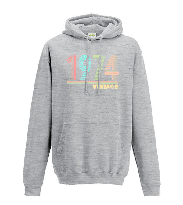 Thumbnail: 1974 in a multicoloured distressed line font with the word vintage underneath on a light grey hoodie