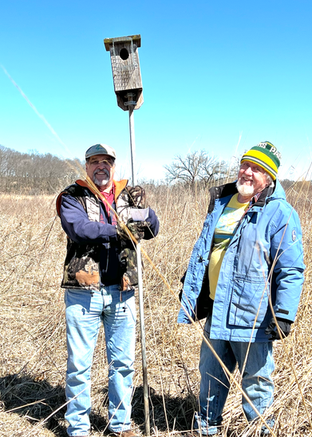 Jim Mand and Paul Noeldner pull up an old nest box to relocate it.