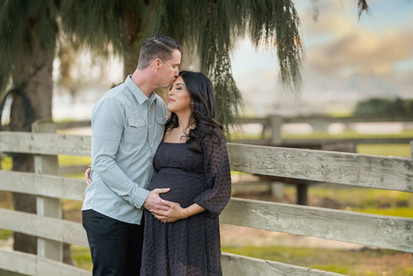 Pregnant mother and her family during an overcast maternity session at Gibson Ranch, captured with soft, natural light. Includes moments with siblings, partner, and a teddy bear holding baby’s heartbeat. Photographed by the best Sacramento maternity photographer.