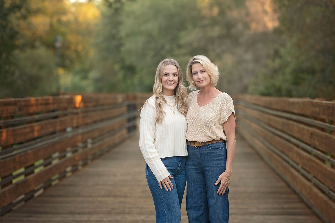 Extended family posing together on a wooden bridge at a Citrus Heights nature reserve during a fall family photography session.