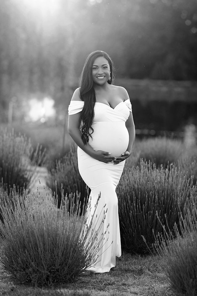 Pregnant woman in maternity gown at lavender farm captured by best Sacramento maternity photographer, featuring romantic outdoor maternity portraits in golden light.