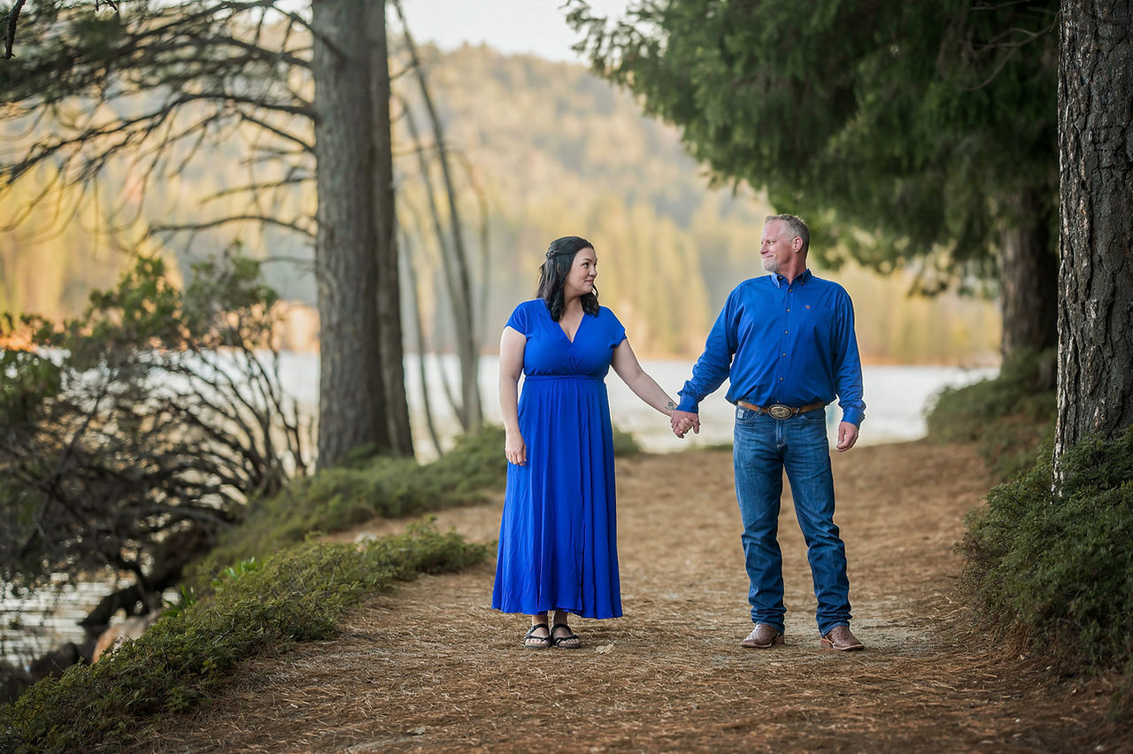Couple posing together at Sly Park near a lake and forest, photographed by the best Sacramento family photographer.