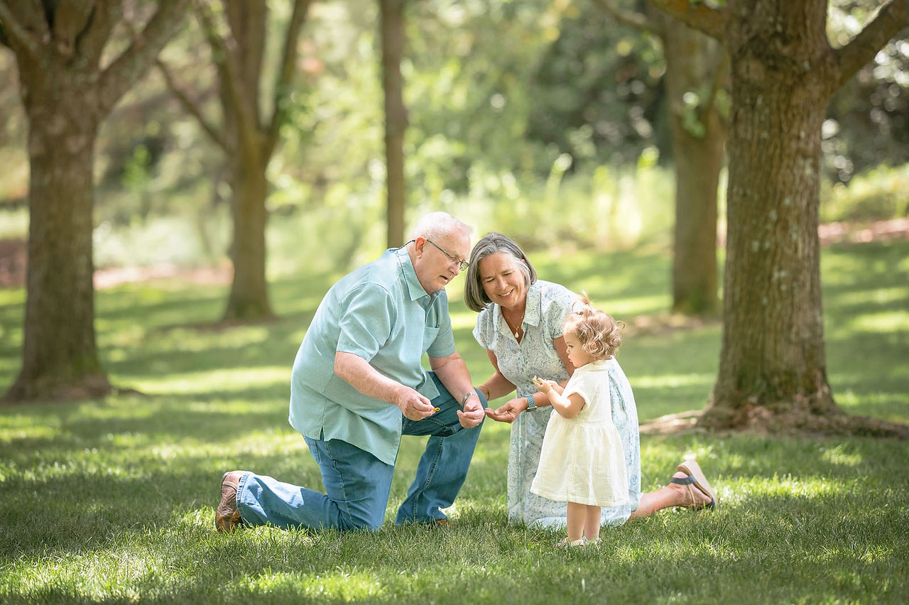 Extended family portraits in Rocklin, California under shaded trees captured by Kristina Martin, best Sacramento family photographer. Group photos, candid hugs, and playful moments celebrating Grandpa’s 80th birthday.
