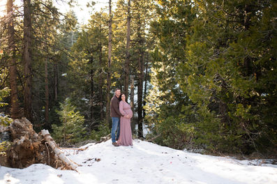Snowy forest maternity session featuring a couple in soft, romantic colors. Captured by Kristina Martin Photography, best Sacramento maternity and newborn photographer.