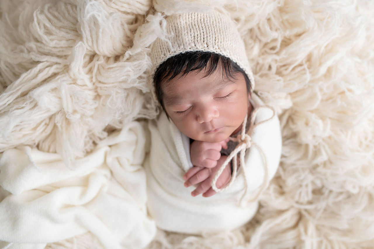 In-home Sacramento newborn photography session featuring family and baby portraits captured in natural light and cozy lifestyle settings.