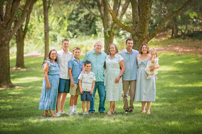 Extended family portraits in Rocklin, California under shaded trees captured by Kristina Martin, best Sacramento family photographer. Group photos, candid hugs, and playful moments celebrating Grandpa’s 80th birthday.