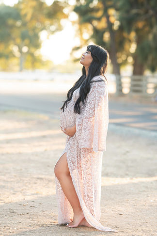 Mother-to-be gazing thoughtfully into the distance, embracing the journey of motherhood in an enchanting outdoor setting, photographed by the best Sacramento maternity photographer.
