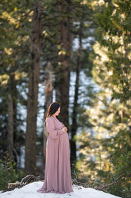Snowy forest maternity session featuring a couple in soft, romantic colors. Captured by Kristina Martin Photography, best Sacramento maternity and newborn photographer.