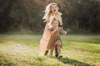 Family portraits at the Iris Farm, featuring a mother and her two daughters, captured by the best Sacramento family photographer.