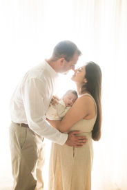 Sweet newborn baby boy peacefully sleeping in a cozy studio setting, wrapped in soft neutrals of cream and white, with delicate details captured like tiny toes, hands, and lashes. Family photos included tender moments with mom and dad. Taken by the best maternity and newborn photographer in Sacramento, Kristina Martin Photography.
