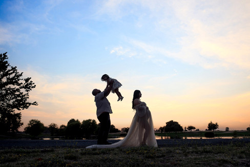 Beautiful maternity session at a Sacramento Ranch in California. Captured by the finest maternity photographer. A mother, her husband, and their shy but sweet daughter during golden California sunset.