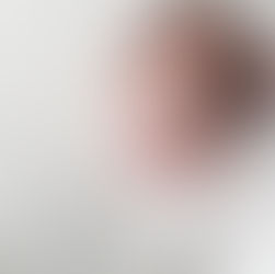 Profile view of a newborn baby girl sleeping, wrapped in a white swaddle on a white knit blanket. Taken by Sacramento maternity and newborn photographer Kristina Martin