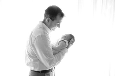Sweet newborn baby boy peacefully sleeping in a cozy studio setting, wrapped in soft neutrals of cream and white, with delicate details captured like tiny toes, hands, and lashes. Family photos included tender moments with mom and dad. Taken by the best maternity and newborn photographer in Sacramento, Kristina Martin Photography.