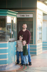 Downtown Roseville family photography session at sunset featuring a playful family walking, laughing, and interacting naturally in an urban setting.