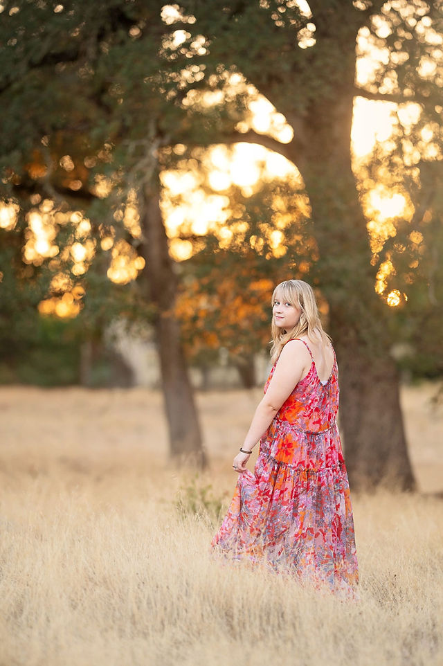 High school senior photographed by Kristina Martin Photography, Sacramento and Roseville senior photographer, in long golden grass during golden hour with soft, wispy light and warm neutral tones.