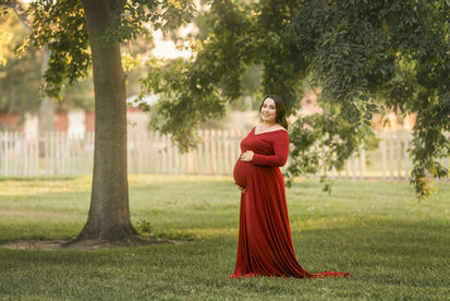 Beautiful maternity photos of Danielle wearing red maternity gown at Gibson Ranch, captured by the best Sacramento maternity photographer Kristina Martin.