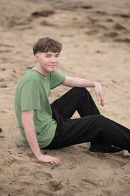 Izzack smiles as he enjoys a moment on the beach. Shot by the best Sacramento senior photographer.
