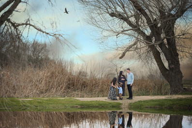 Pregnant mother and her family during an overcast maternity session at Gibson Ranch, captured with soft, natural light. Includes moments with siblings, partner, and a teddy bear holding baby’s heartbeat. Photographed by the best Sacramento maternity photographer.