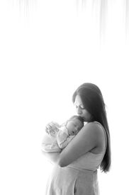 Sweet newborn baby boy peacefully sleeping in a cozy studio setting, wrapped in soft neutrals of cream and white, with delicate details captured like tiny toes, hands, and lashes. Family photos included tender moments with mom and dad. Taken by the best maternity and newborn photographer in Sacramento, Kristina Martin Photography.