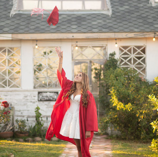 Senior portrait session at a flower farm in Sheridan, California with seasonal flowers, a greenhouse, arches, and warm sunset light.