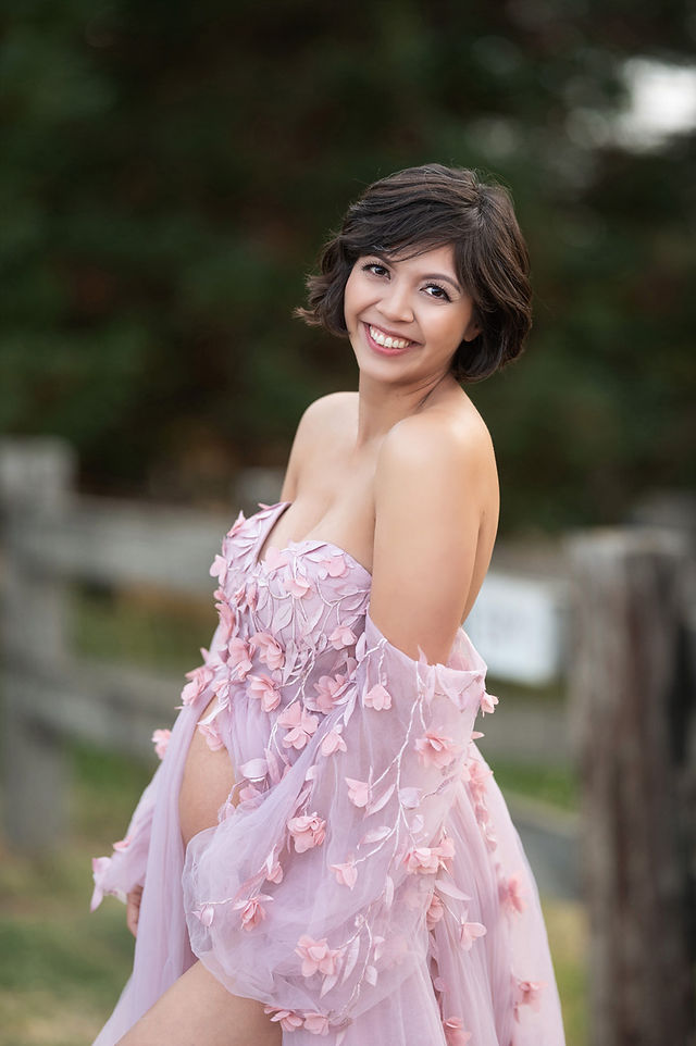 Beautiful maternity session at a dreamy lavender farm in Lincoln, California. Captured by the best Sacramento maternity photographer, the photos feature a glowing mom-to-be in stunning gowns with backdrops like a serene pond, lush trees, a rustic barn, a dock at sunset, and even a white horse offering sweet pony kisses to her baby bump.