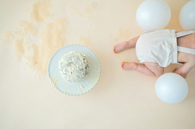 One year old baby boy sitting in a neutral white and cream studio setup in Roseville, soft natural light, minimal styling, and timeless milestone photography by a Sacramento baby photographer.