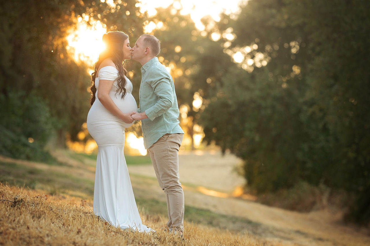 Valentina’s maternity session at Gibson Ranch featuring soft golden-hour light, neutral-toned gowns, and a radiant mom-to-be posing with her husband in scenic outdoor settings, taken by the best Sacramento photographer, Kristina Martin.