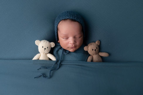 A gallery of newborn session images featuring a swaddled baby in simple, cozy setups. The photos capture a variety of angles, showing the baby peacefully resting in natural, comfortable poses. Some images are taken on a soft white backdrop, while others include a blue background or warm, textured blankets taken by Sacramento Maternity and Newborn photographer Kristina Martin Photography.