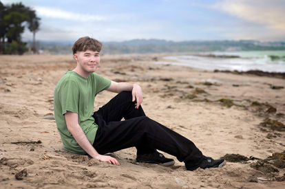 Izzack smiles as he enjoys a moment on the beach. Shot by the best Sacramento senior photographer.