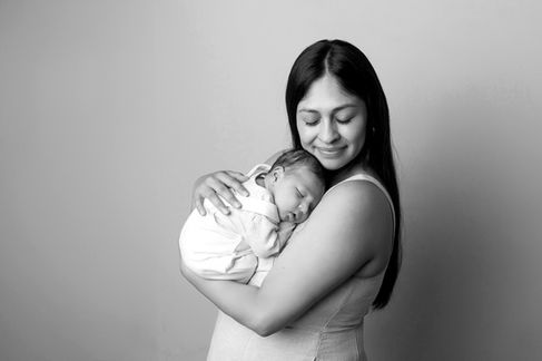 Sweet newborn baby boy peacefully sleeping in a cozy studio setting, wrapped in soft neutrals of cream and white, with delicate details captured like tiny toes, hands, and lashes. Family photos included tender moments with mom and dad. Taken by the best maternity and newborn photographer in Sacramento, Kristina Martin Photography.