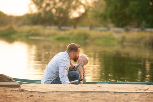 Expecting family with a young child during a golden hour maternity photography session at the Lavender Farm in Lincoln, California.
