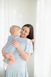 One year old baby boy sitting in a neutral white and cream studio setup in Roseville, soft natural light, minimal styling, and timeless milestone photography by a Sacramento baby photographer.