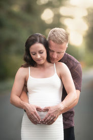 A glowing maternity session at the Davis Arboretum near Sacramento, captured by Kristina Martin Photography. The expecting couple stands in natural, serene surroundings, illuminated by soft golden light, celebrating their upcoming arrival.