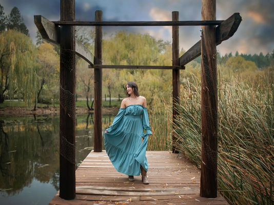 High school senior posing among fall foliage during a senior photography session in Apple Hill, California.