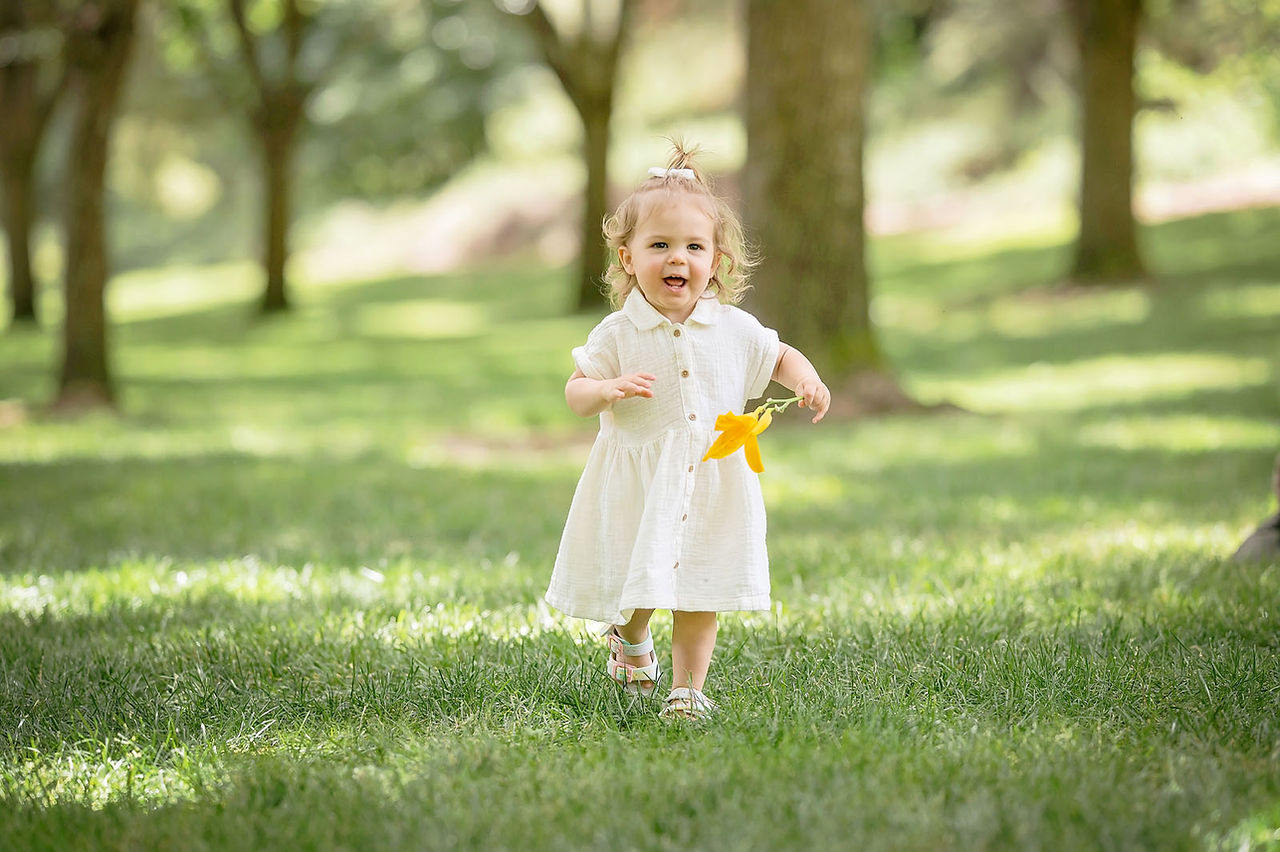 Extended family portraits in Rocklin, California under shaded trees captured by Kristina Martin, best Sacramento family photographer. Group photos, candid hugs, and playful moments celebrating Grandpa’s 80th birthday.