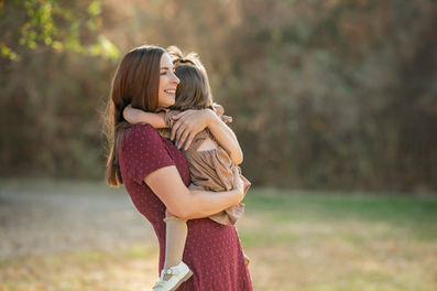 Family portraits at the Iris Farm, featuring a mother and her two daughters, captured by the best Sacramento family photographer.