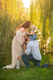 Expecting family with a young child during a golden hour maternity photography session at the Lavender Farm in Lincoln, California.