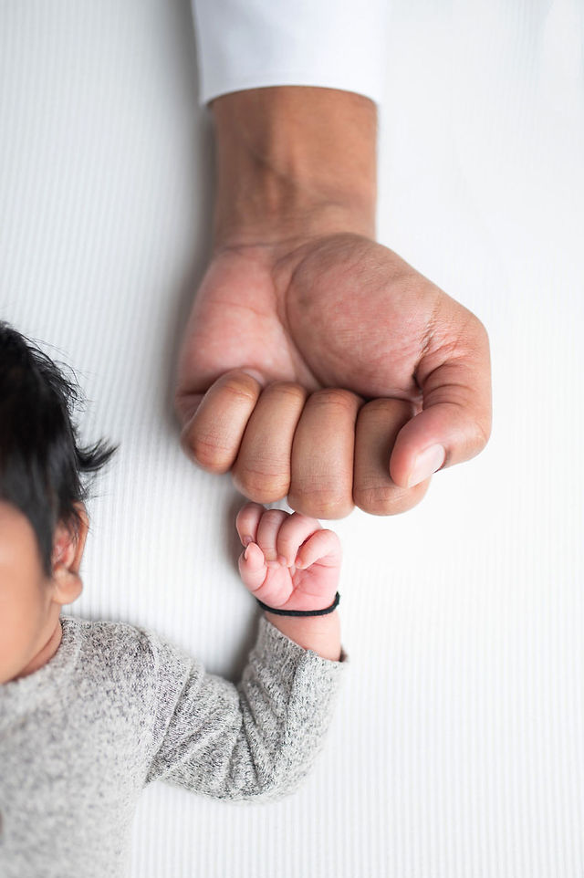 In-home Sacramento newborn photography session featuring family and baby portraits captured in natural light and cozy lifestyle settings.