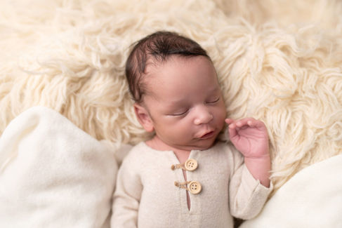 A gallery of newborn session images featuring a swaddled baby in simple, cozy setups. The photos capture a variety of angles, showing the baby peacefully resting in natural, comfortable poses. Some images are taken on a soft white backdrop, while others include a blue background or warm, textured blankets taken by Sacramento Maternity and Newborn photographer Kristina Martin Photography.
