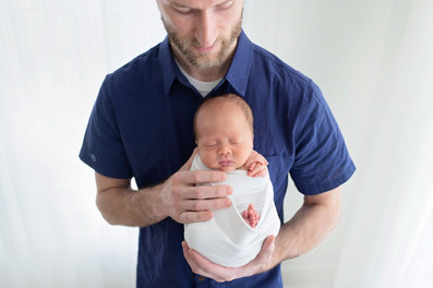 Newborn baby Owen peacefully posed during a simple, classic Sacramento and Roseville studio newborn photography session with soft neutral tones and gentle wrapping.