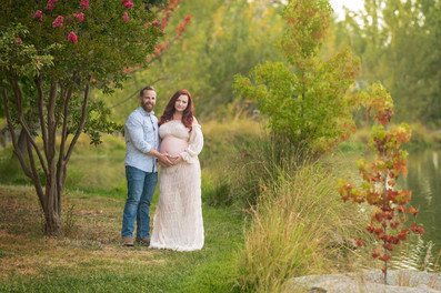 Expecting family with a young child during a golden hour maternity photography session at the Lavender Farm in Lincoln, California.